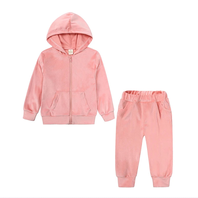 A pink velvet kids tracksuit set featuring a hooded zipper jacket and matching pants.