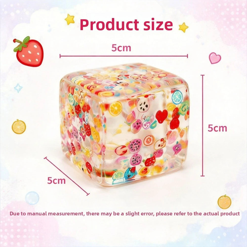 A clear, colorful fruit ice cube stress ball with various fruit shapes inside, shown next to size measurements.