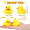 A yellow silicone duck bath toy is shown next to a hand, illustrating its size.