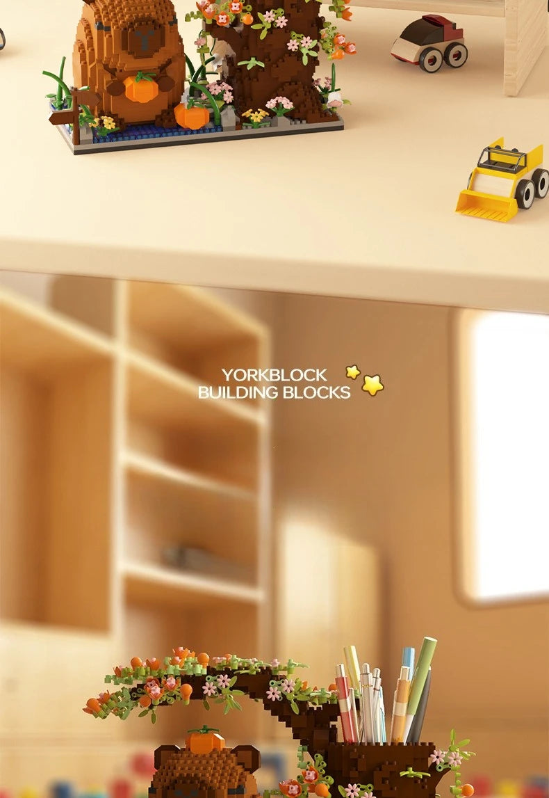Yorkblock building blocks featuring a wooden capybara and orange flowers on a light desk surface.