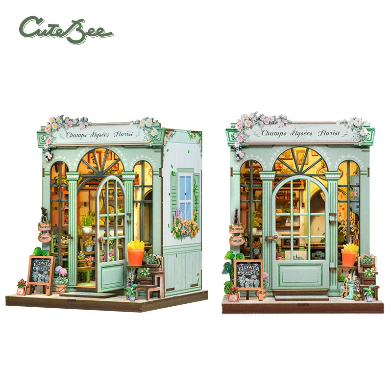 A miniature 3D wooden book nook kit featuring a charming shop facade with glass windows and floral decorations.