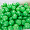 A pile of bright green plastic play balls for games and ball pits.