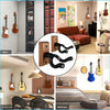 A collection of various stringed instruments including guitars and ukuleles are displayed on a modern wall mount in an office