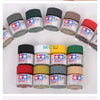 A collection of matte acrylic paint pots in various colors including red, yellow, green, and brown for model kits.