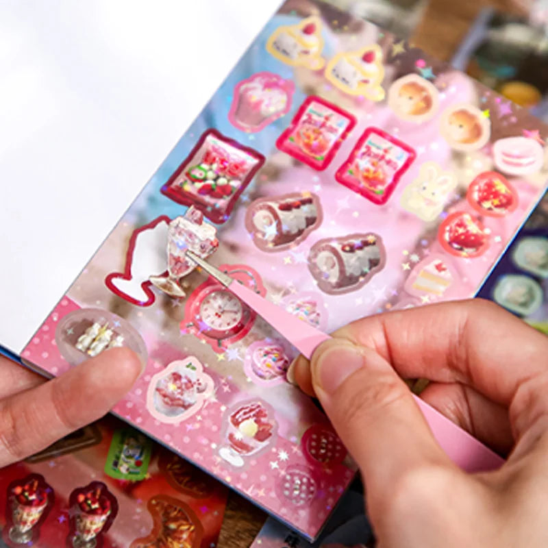 A hand is using a tool to remove a Japanese vintage kawaii sticker from a sheet of pink and white stickers for scrapbooking.