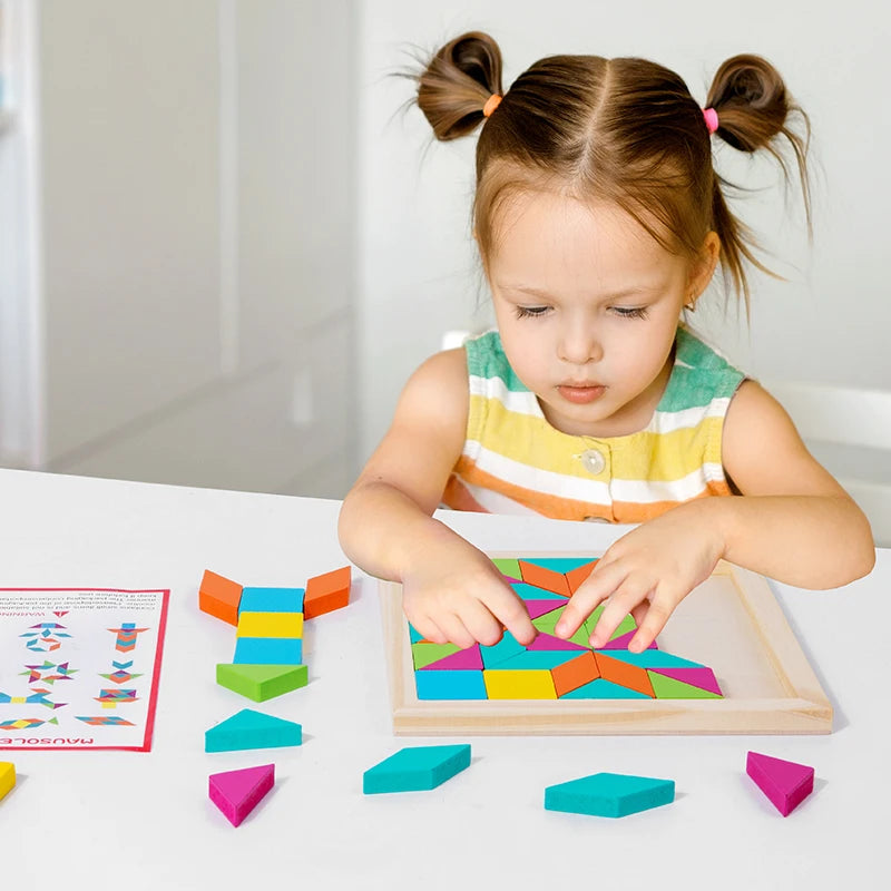 A young girl is assembling a wooden geometric shape puzzle with colorful blocks on a white table.
