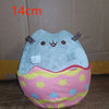A light blue anime-inspired plush cat doll sitting in a pink and yellow polka-dotted fabric egg shape.