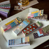A collection of vintage washi paper sticker sheets featuring grid patterns and decorative designs for scrapbooking.