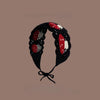 A black crochet headband featuring red strawberry motifs and a wide elastic band.