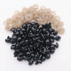 A pile of black plastic safety eyes with washers for crafting and stuffed animals