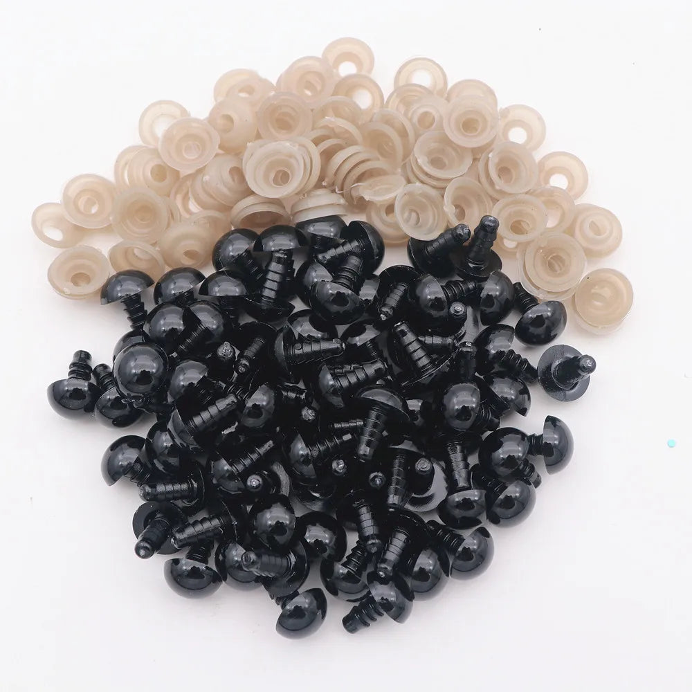 A pile of black plastic safety eyes with washers for crafting and stuffed animals