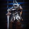 A highly detailed silver and gold metal figurine of a futuristic warrior or adjudicator standing on a dark platform.