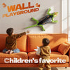 A child is playing with a wall-climbing RC gecko toy against a background featuring the Wall Playground text.