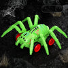A bright green inertia-powered spider crawling toy car is shown on a dark, rocky surface.