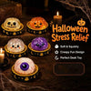 A collection of Halloween-themed squishy fidget toys including pumpkin and ghost shaped items displayed on a dark wooden surf