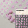 Embossment nail art stickers featuring pink and purple hearts on a light background