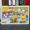 A colorful wooden jigsaw puzzle featuring various cute animals like a girl, a frog, and a rabbit in a garden setting.