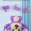 Un jouet singe électrique violet à roulettes, montré dans diverses poses et de face, conçu pour les enfants.