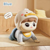A cute baby doll wearing a light gray outfit and hood is shown crawling on a wooden floor.