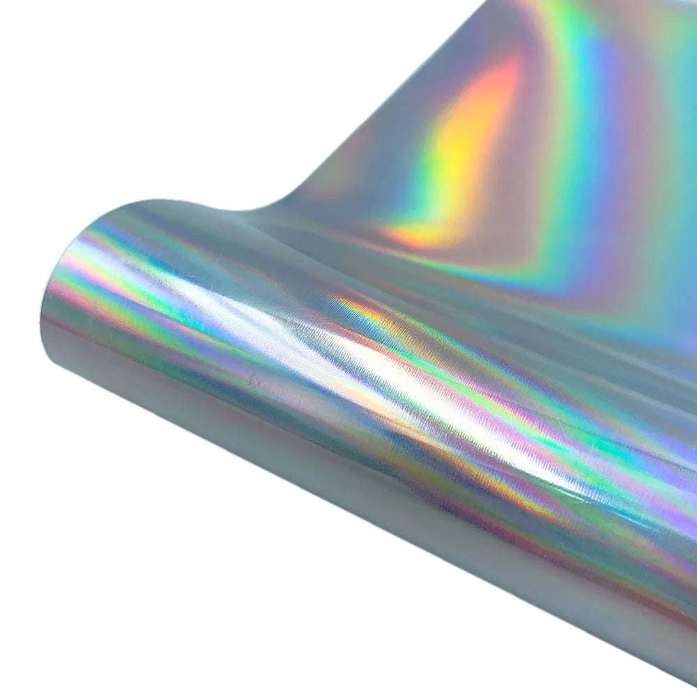 A roll of holographic glitter heat transfer vinyl showing iridescent rainbow colors.