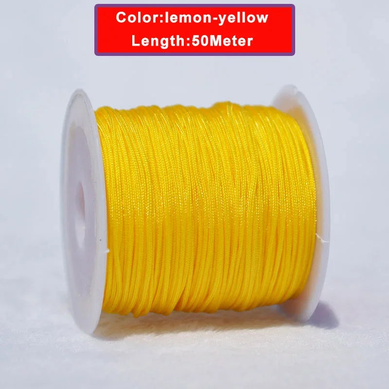 Yellow lemon-yellow nylon knotting cord for jewelry making, 50 meters long and wound on a spool.
