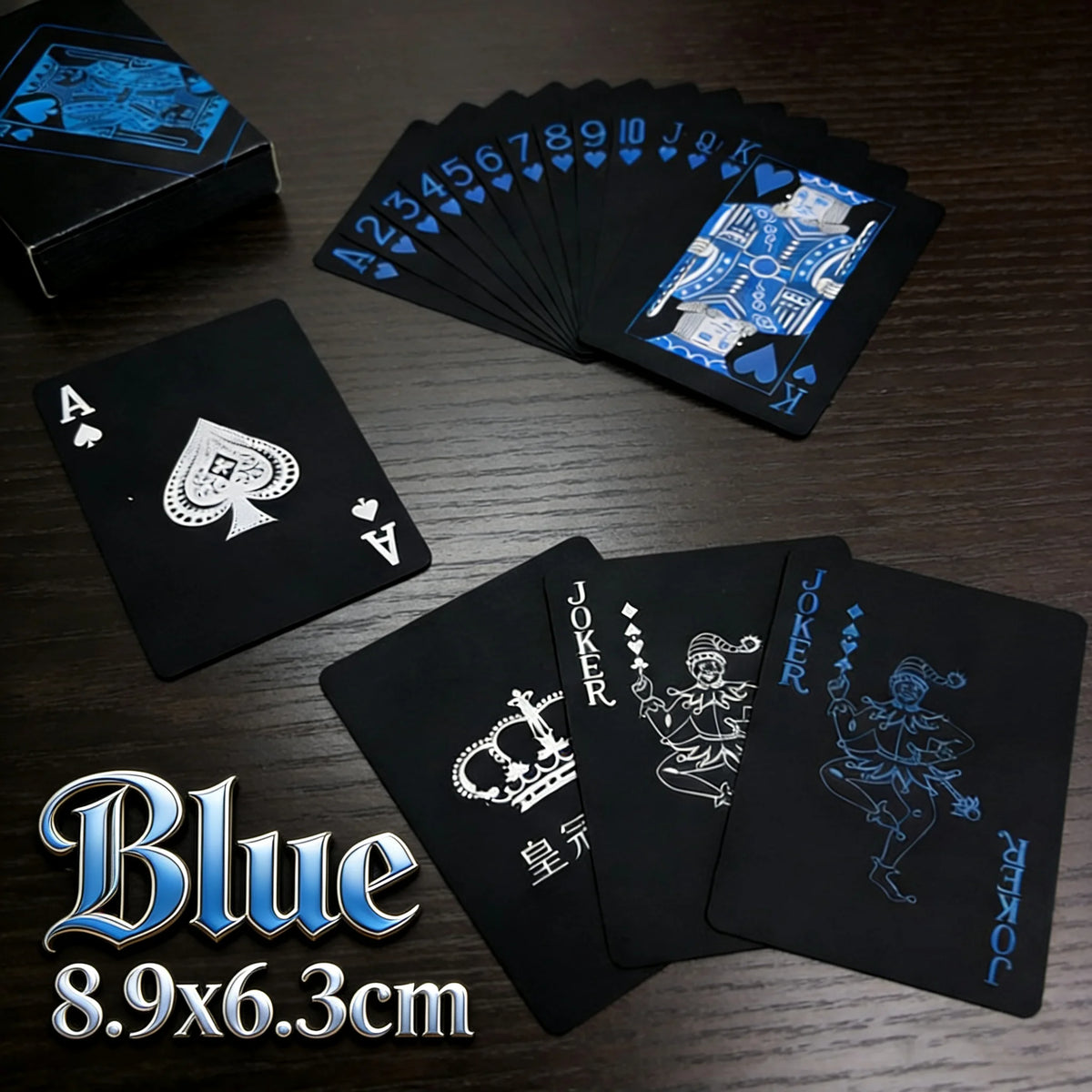 A set of blue playing cards and a joker card displayed on a dark wooden surface.
