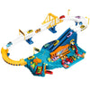 A yellow and blue dinosaur rail car adventure playset featuring a track, building, and parking lot area.