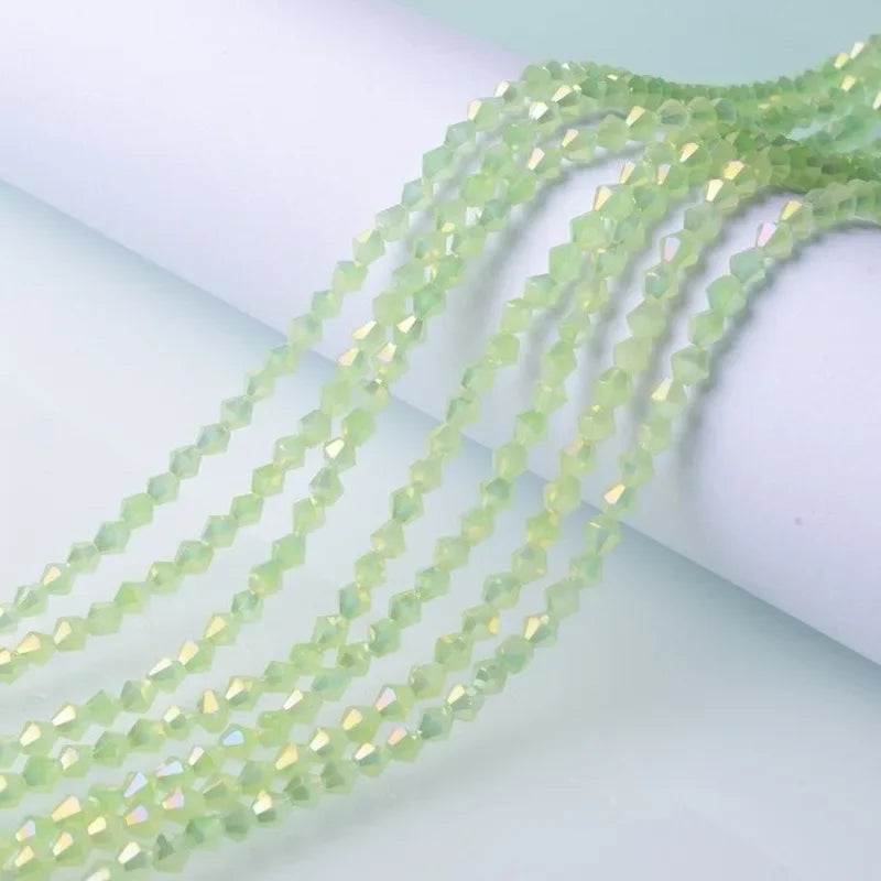 Green faceted glass crystal beads strung together in a delicate strand for jewelry making