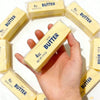 A hand holds a stick of salted butter, surrounded by other butter sticks.