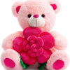A pink plush bear holding a large, vibrant pink rose flower.
