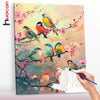 A painting featuring various colorful birds perched on branches with pink flowers, done in a paint by numbers style.