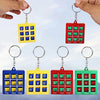 A set of mini tic tac toe puzzle game keychains in blue, yellow, and red colors.