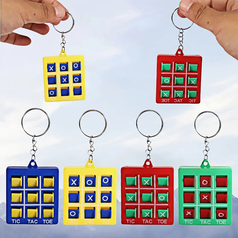 A set of mini tic tac toe puzzle game keychains in blue, yellow, and red colors.