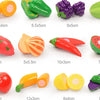 A collection of plastic fruits and vegetables for kids pretend play including tomatoes, peppers, cucumbers, and melons.