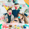 A girl and a boy are surrounded by assorted mini animal plush toys and gifts.