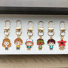 A set of six metal keychains featuring character pendants from Stranger Things.