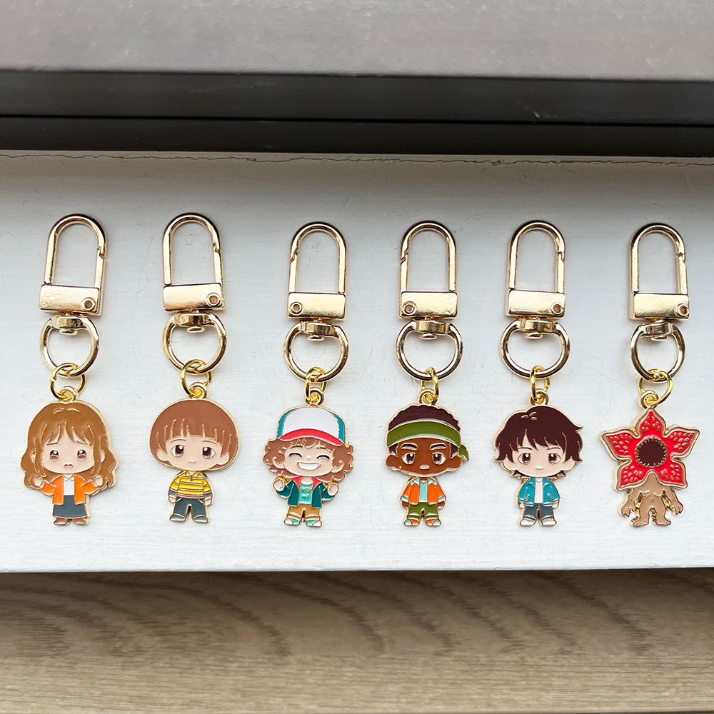 A set of six metal keychains featuring character pendants from Stranger Things.