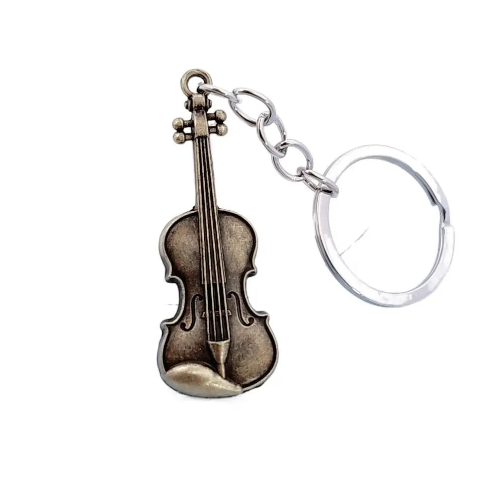 A vintage violin keychain featuring a metallic brown body and silver hardware.