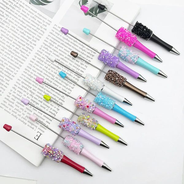 A collection of twelve ballpoint pens featuring various colors and glittery sequin designs.