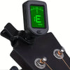 Black clip-on digital tuner with a green display and guitar picks attached.