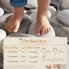 A size chart showing measurements for baby shoes and insoles, with a baby's feet resting on smooth stones.