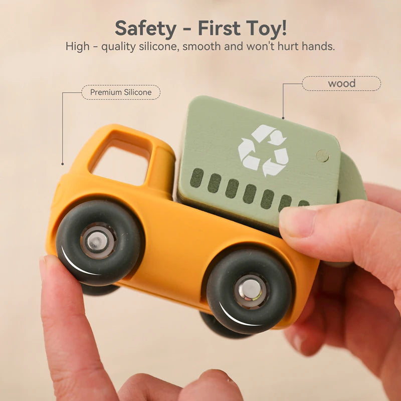 A hand holds a yellow silicone toy car, demonstrating its smooth texture and safety features.