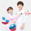 A young boy and girl playing doctor with a pretend medical kit featuring round earpieces and a heart beat monitor.