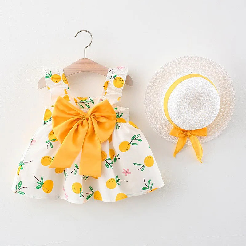 A yellow and white floral baby girl summer dress and sunhat set with bow details.