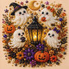 A detailed seasonal art kit featuring white ghost figures, pumpkins, and decorative elements made with pearl and glitter.