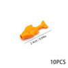 An orange plastic fish shape used as an ocean animal building block.