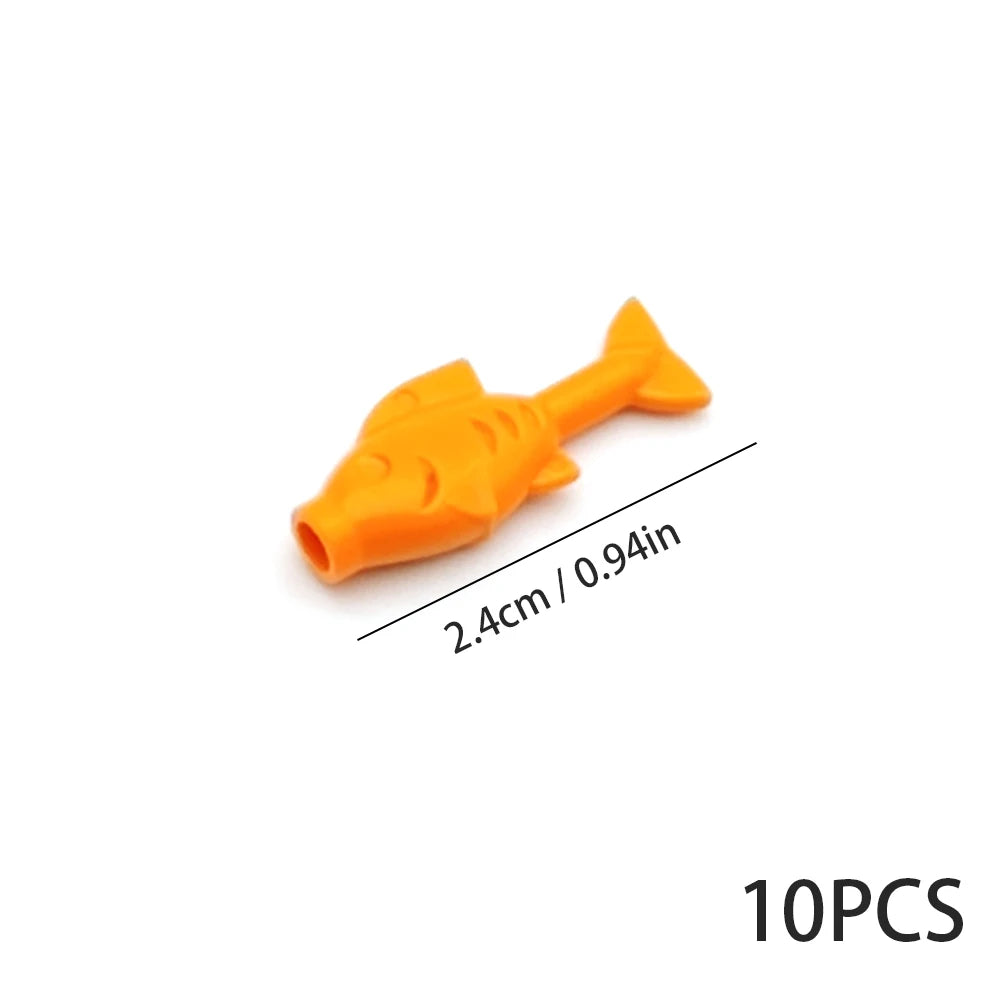 An orange plastic fish shape used as an ocean animal building block.