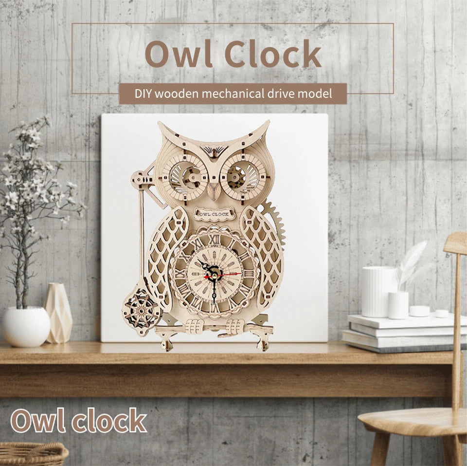 DIY wooden mechanical owl clock model displayed on a wooden shelf against a gray textured wall.