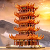 A detailed model of the Yellow Crane Tower built from orange and brown LEGO-style blocks against a sunset backdrop.