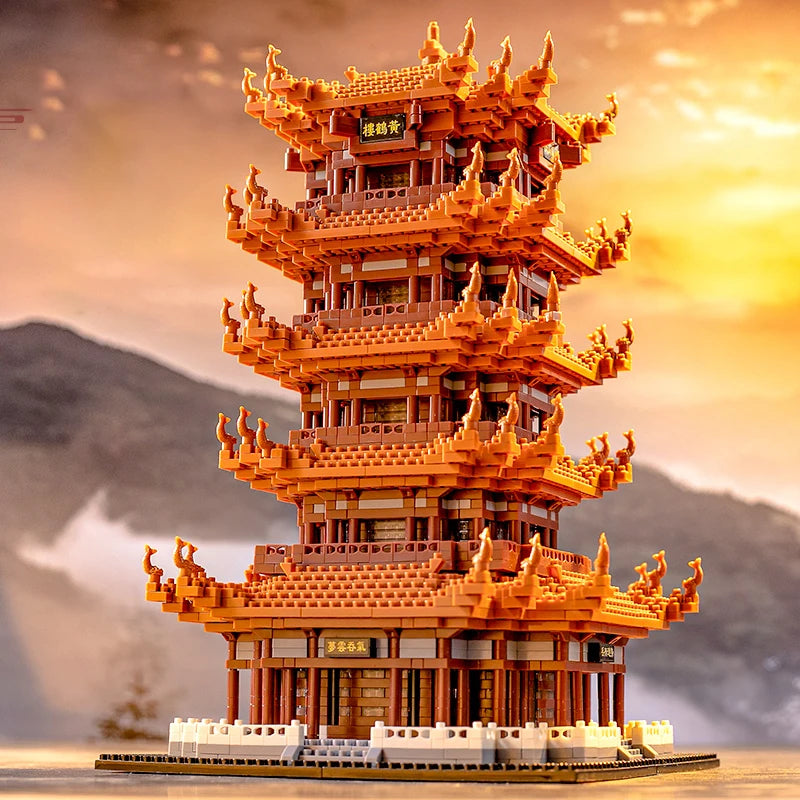 A detailed model of the Yellow Crane Tower built from orange and brown LEGO-style blocks against a sunset backdrop.